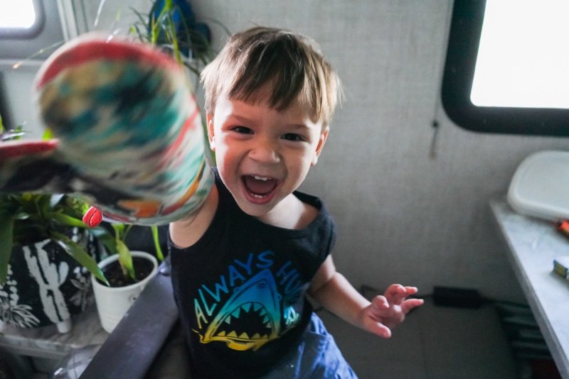 little boy playing with an oven mitt