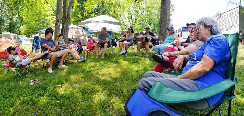 A group of campers sitting altogether and talking. Rules for Campers - Group Camping