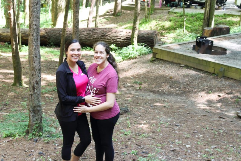 two pregnant women camping outdoors