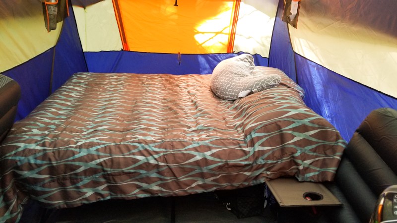 camping when pregnant tent set up with a queen size air mattress on a cot and maternity pillow