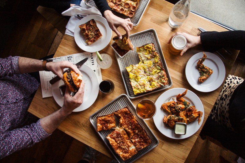 Photo of people eating at Emmy Squared Restaurant at The Gulch in Nashville.