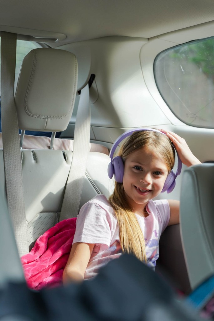 a girl listening to music on her table during a road trip