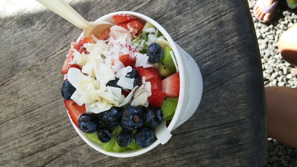 An acai bowl filled with fruits and coconut shavings from Hale'iwa Bowls. Posted on a travel guide that features the best things to do with kids on Oahu, Hawaii. 