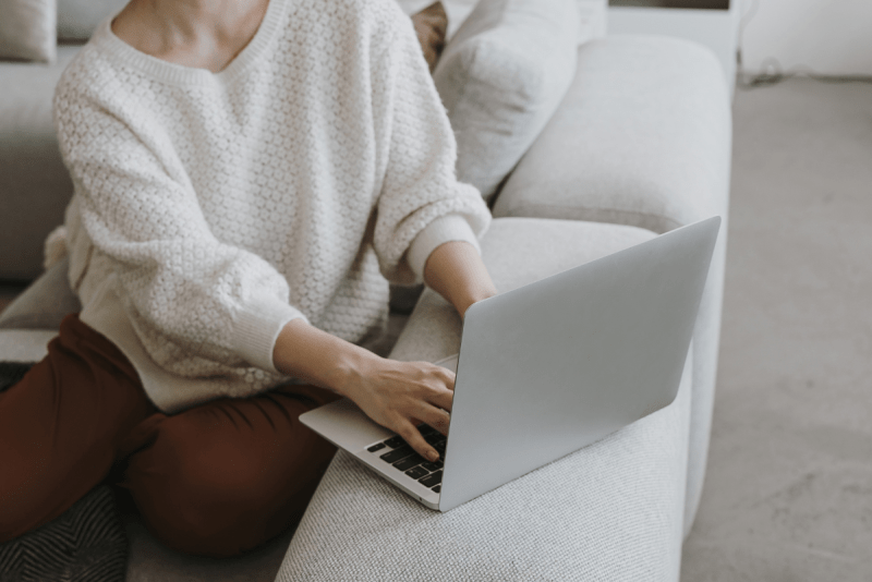 a woman on her laptop working from home as a travel agent