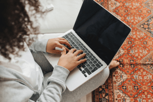 a woman on her laptop working from home as a travel blogger