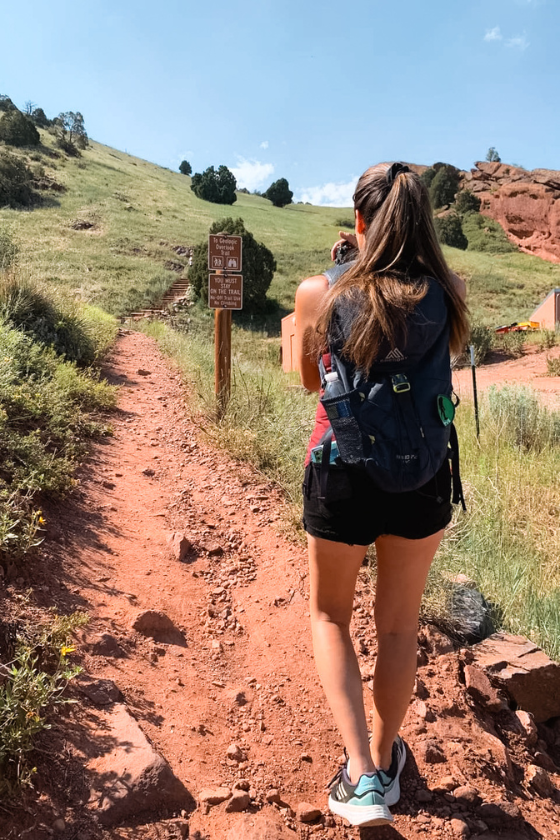 A woman (Jessica Tejera) taking pictures during a hike at Denver, Colorado. Published on an article that teaches others how to become independent travel agents and how to travel more as a travel agent. 