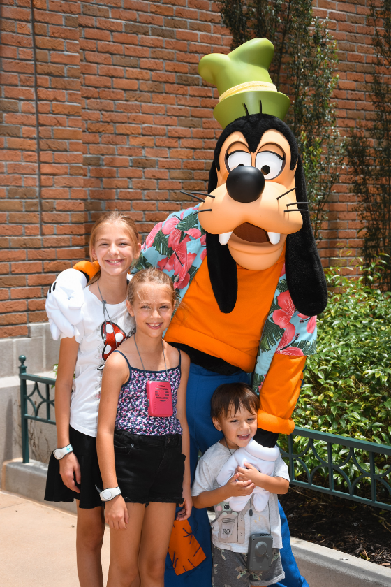 The Walking Mermaid kiddos meeting Goofy at Disney's Hollywood Studios at Walt Disney World in Orlando, Florida. Published on an article that teaches others how to become independent travel agents and how to travel more as a travel agent.