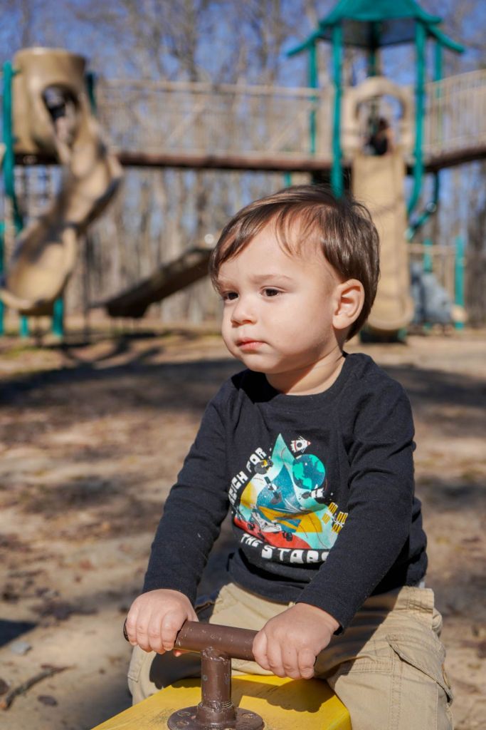 A boy playing at a playground in Monte Sano State Park