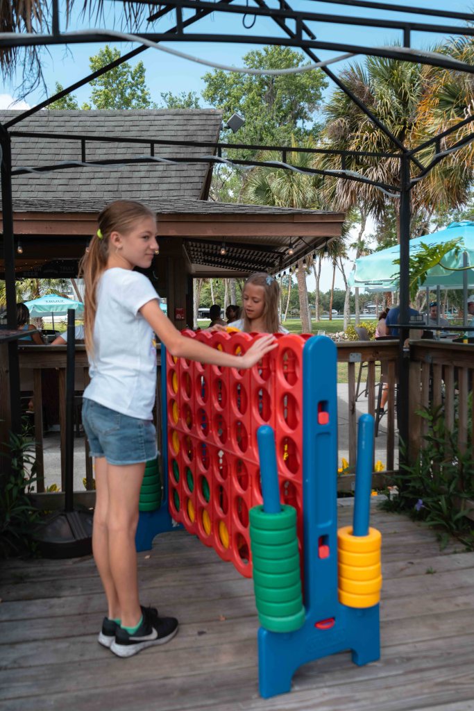 Girls playing connect four at Plantation on Crystal River.