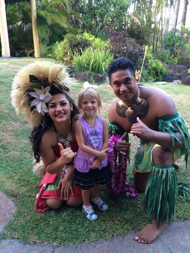 Girl with Hawaiians at the Ali'i Luau at the Polynesian Cultural Center attraction in Oahu, Hawai'i.