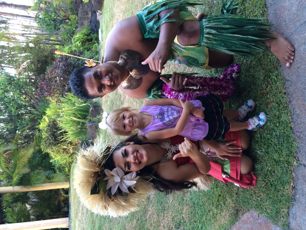 Girl with Hawaiians at the Ali'i Luau at the Polynesian Cultural Center attraction in Oahu, Hawai'i. 