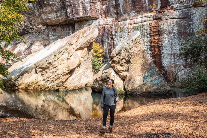 A woman standing in front of the stones at Devil's Backbone at Shawnee National Forest