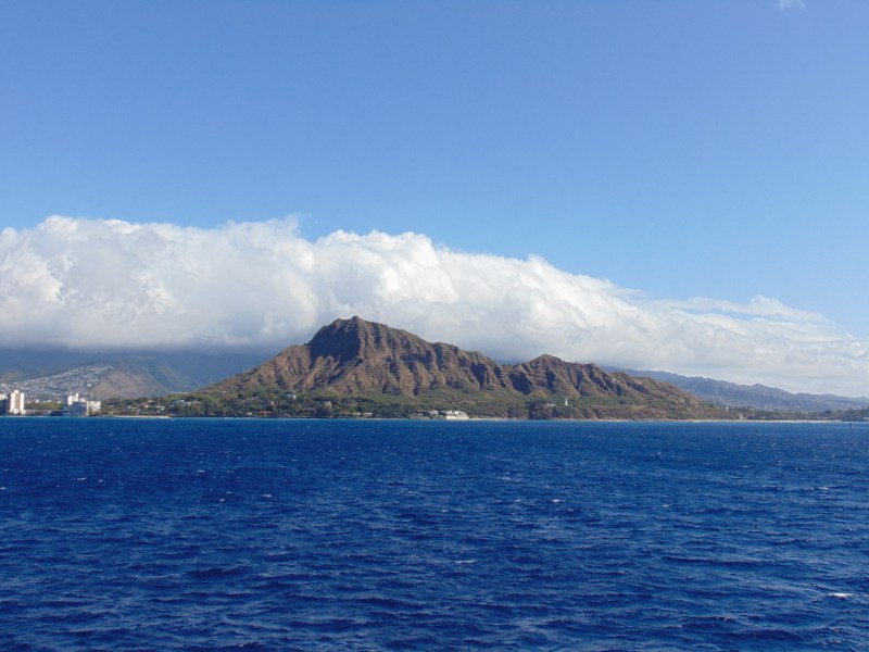 An ocean view of Diamond Head Crater taken during a whale watching boat tour in Honolulu. Posted on a travel guide that features the best things to do with kids on Oahu, Hawaii. 