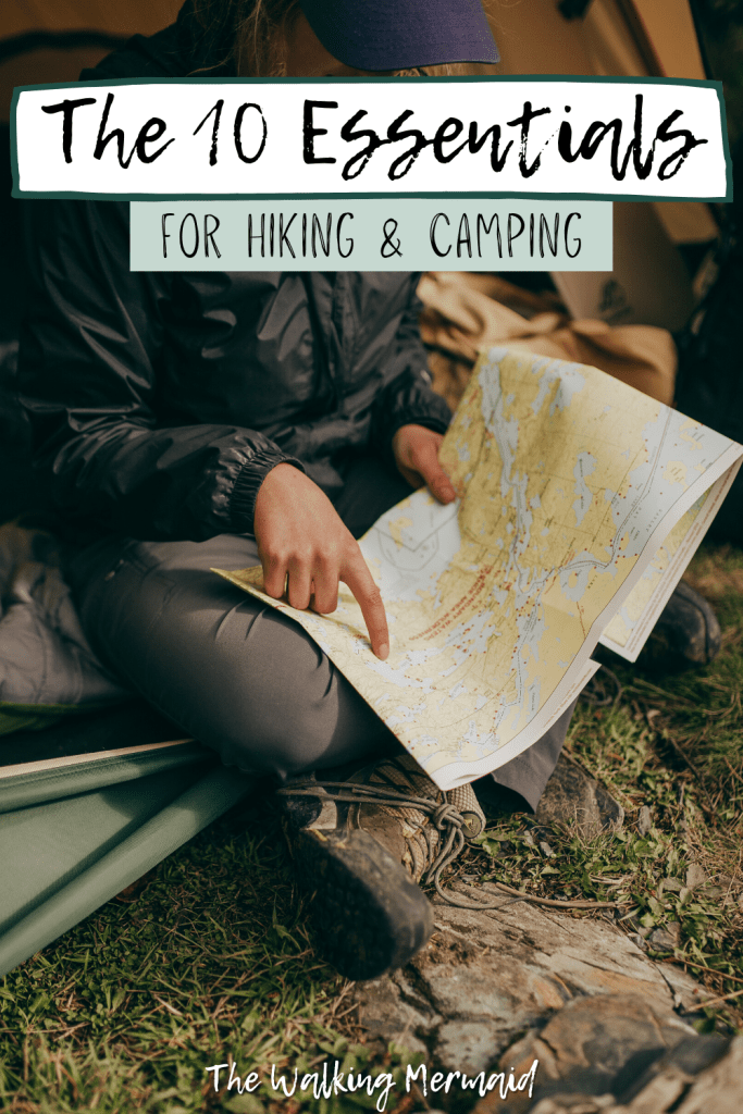 Woman pointing at a map sitting in her tent. Posted on a blog post that talks about the ten essentials for camping and hiking.