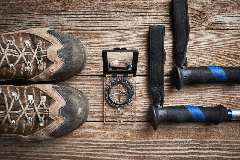 hiking boots, trekking poles, and a compass for navigation. ten essentials for hiking and camping