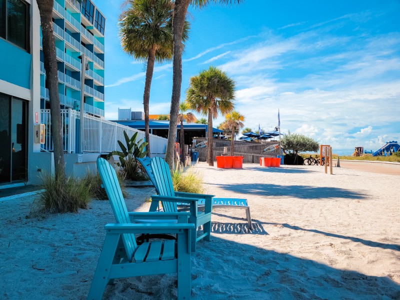 Beach chairs and a view of the pool and Sloppy Joe's at the Bilmar Beach Resort at Treasure Island