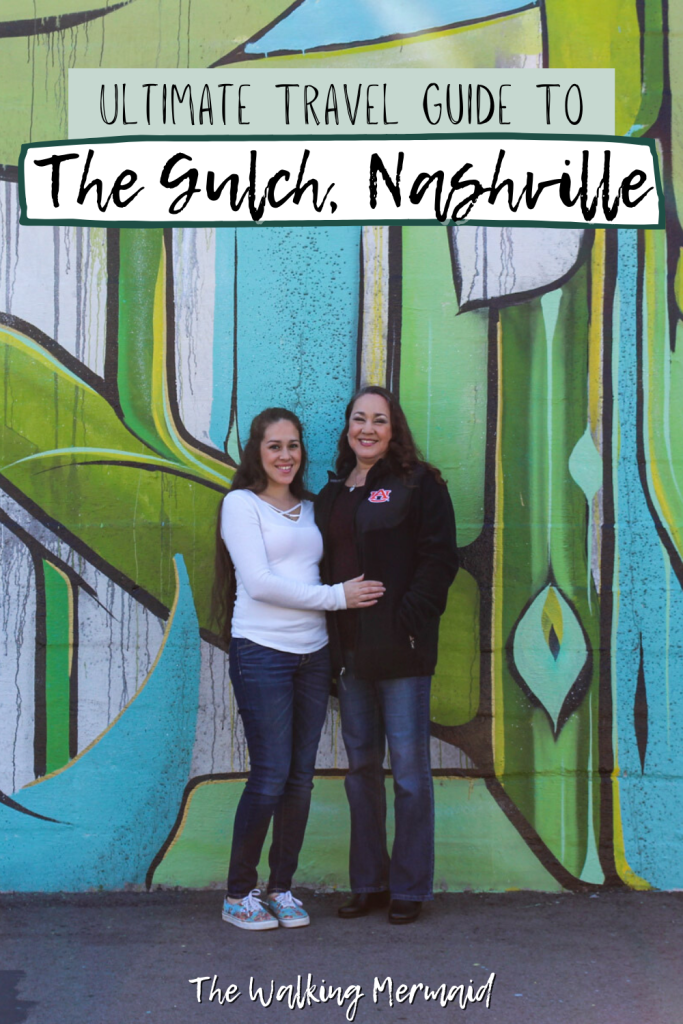 Ultimate Travel Guide To The Gulch in Nashville, Tennessee. A mom and a daughter posing by a mural at The Gulch.