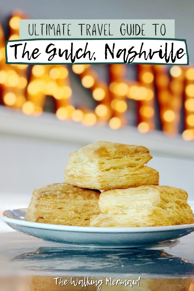 Ultimate Travel Guide To The Gulch in Nashville, Tennessee. Plate of biscuits from Biscuit Love at The Gulch with a Nashville sign behind it.