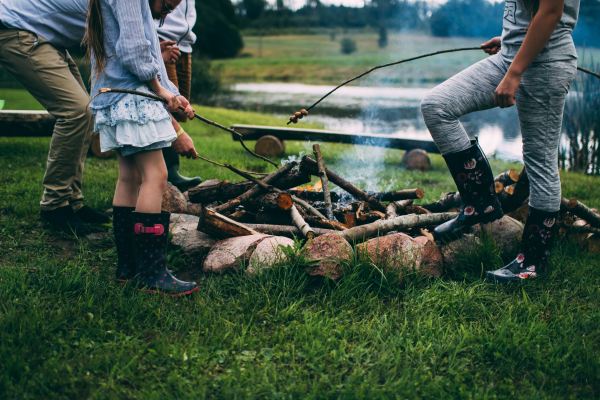 camping with kids roasting marshmallow food by the fire family camp